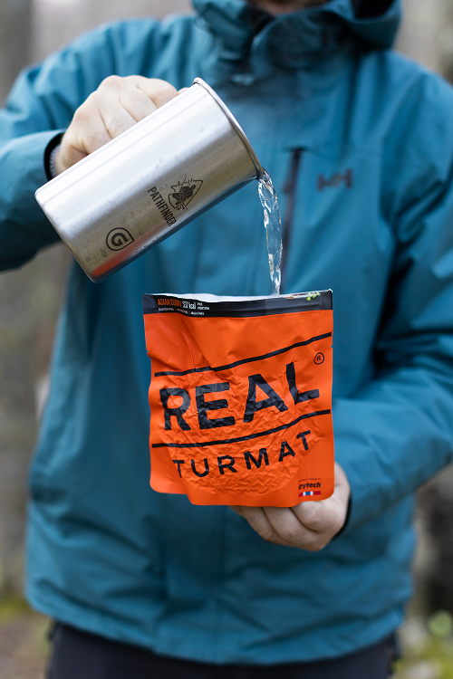 man filling real turmat with water