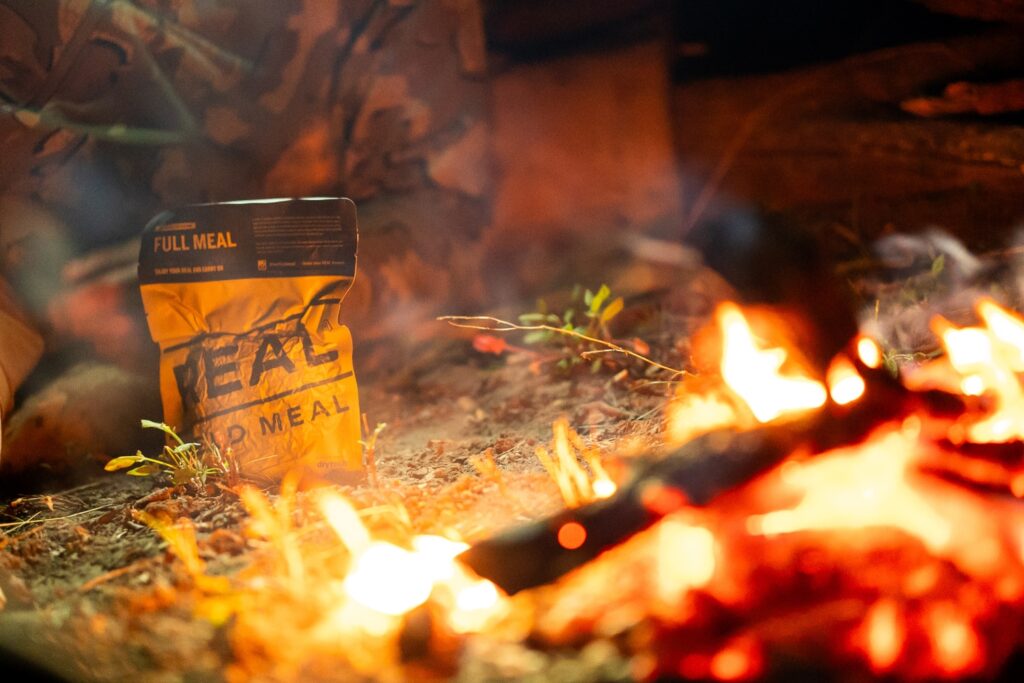 real field meal pouch beside a fire
