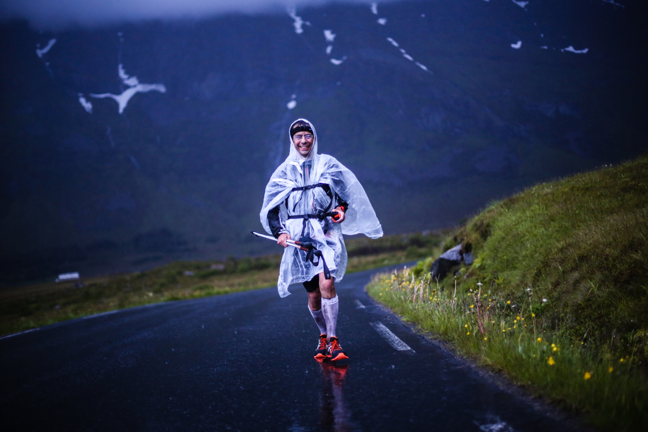 man running in a rain on a dark day