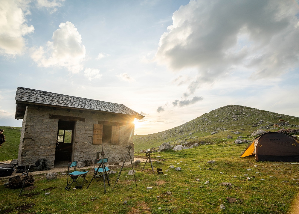 stone cabin in a green field 1000x714