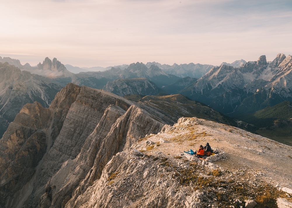 people sitting on a mountain taking a break