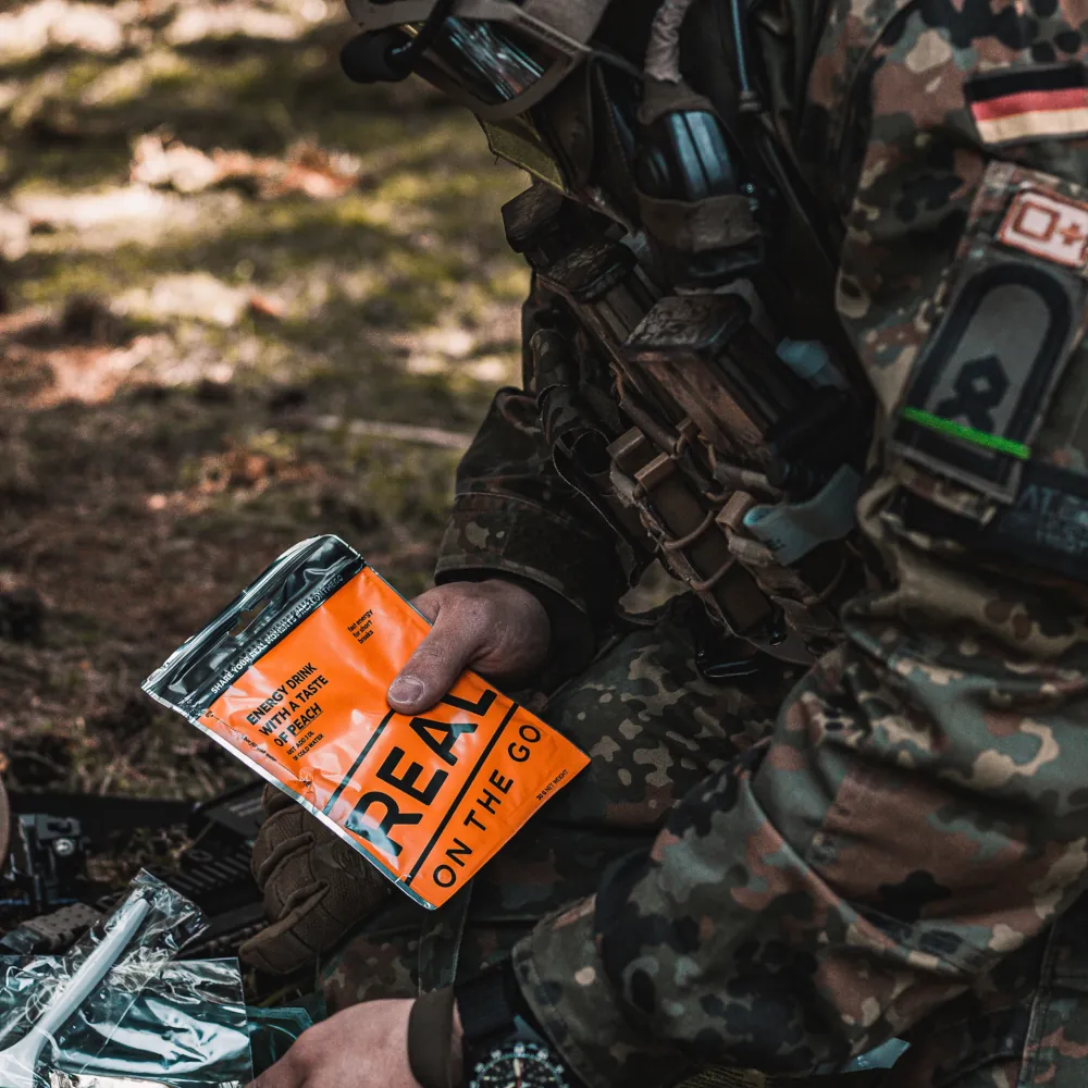 energy drink in the hands of a soldier