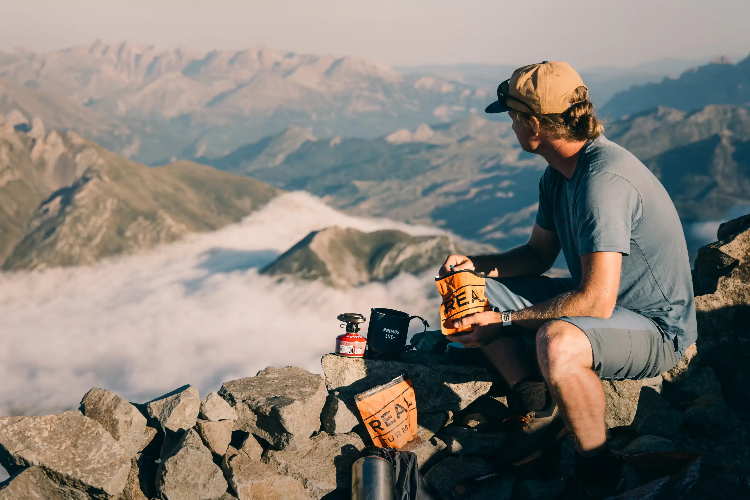 person eating real turmat and enjoying the mountain view