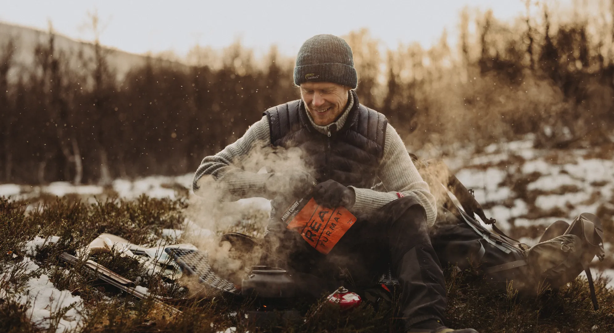 man in autumn preparing food